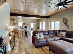 a living room with a couch and a ceiling fan at Big and Boulder in McHenry