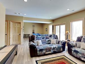 a living room with two chairs and a couch at Big and Boulder in McHenry +86 photos