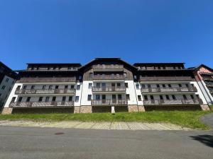 a large white building with a lot of windows at Apartmán pod Prokopem in Železná Ruda +10 photos