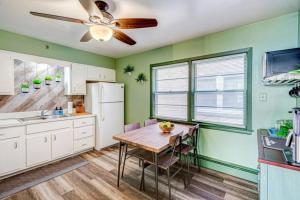 a kitchen with a table and a ceiling fan at Top Rated Condo - Historic Location in Elmwood Park +8 photos
