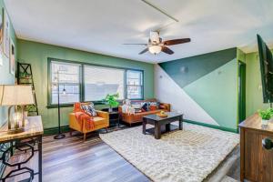 a living room with green walls and a ceiling fan at Top Rated Condo - Historic Location in Elmwood Park