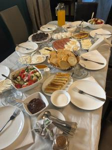 a table topped with plates and bowls of food at Borjomi Central in Borjomi