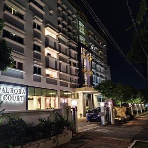 a building with a car parked in front of it at Aurora Court Service Apartment in George Town