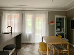 a kitchen with a table and chairs and a dining room at Amazing Spot in the Heart of Akureyri in Akureyri