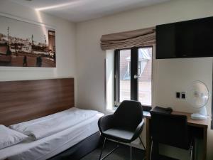 Giường trong phòng chung tại Hotel Jomfru Ane