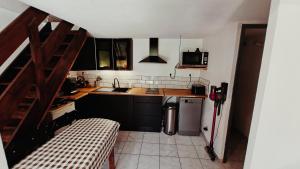 a small kitchen with a sink and a refrigerator at pavillon 40m2, 2 Chambres, 1 salon cuisine, 1sdb in Gruissan +3 photos