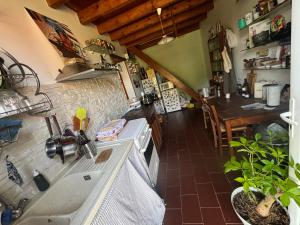 a kitchen with a sink and a stove at Chez Benoit, séjour Zen, chambre d'amis in Mazerolles