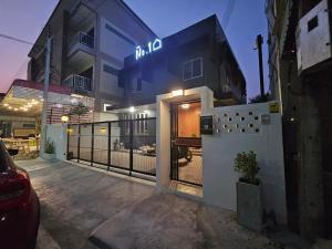 a house with a gate in front of a building at No.10 HOSTEL- Prachuap Khiri Khan in Prachuap Khiri Khan