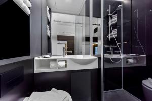 a bathroom with a sink and a shower at The Z Hotel Holborn in London