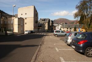 a street with cars parked in a parking lot at Appartement Les Amethystes 1 in Le Mont-Dore