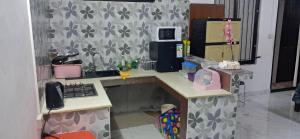 a toy kitchen with a counter and a refrigerator at The guest house in Port Louis