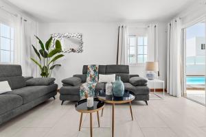 a living room with a couch and a table at Villa Atlántica - Heated pool in Playa Blanca in Playa Blanca