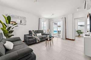 a living room with a couch and a table at Villa Atlántica - Heated pool in Playa Blanca in Playa Blanca