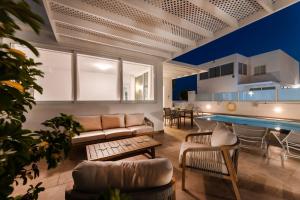 a living room with a couch and a pool at Villa Atlántica - Heated pool in Playa Blanca in Playa Blanca