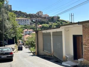 a car parked on a street next to a garage at Guni Inn in Krujë +11 photos