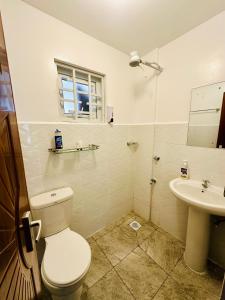 a bathroom with a toilet and a sink at Sweet Homes furnished apartments Nakuru in Nakuru +34 photos