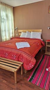a bedroom with a large bed with a red blanket at kuntur inn hotel in Puno +105 photos