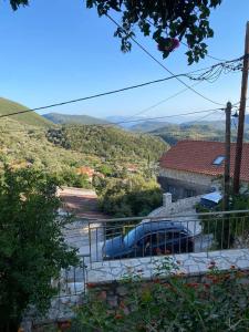 a blue car parked in a parking lot next to a building at Traditional House with breathtaking view, Makis in Sívros
