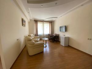 a living room with two chairs and a table at Hotel Oasis in Kapan
