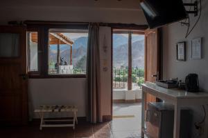 a kitchen with a window and a view of a mountain at La Llama Negra in Tilcara