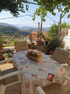 a table and chairs on a patio with a view at Traditional House with breathtaking view, Makis in Sívros