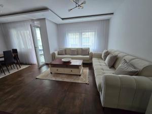a living room with a couch and a table at Rila Apartment in Gnjilane