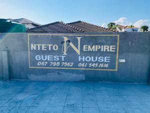 a sign for a guest house on a wall at Nteto guesthouse in Dwarsloop