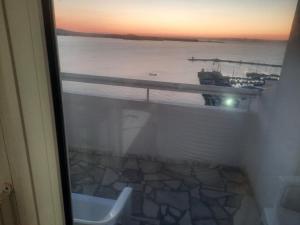 a bathroom with a view of the ocean and a toilet at ORION Guest House in Sozopol +89 photos