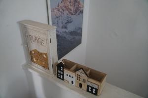 a toy house in a box sitting on a shelf at Sofia's house in Possidi