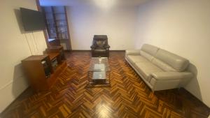 a living room with a couch and a coffee table at La Pascana Hospedaje in Cajamarca