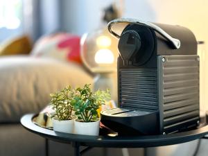 a computer on a table with potted plants on it at River 2-Bedroom Apartment with Terrace in Alcântara in Lisbon