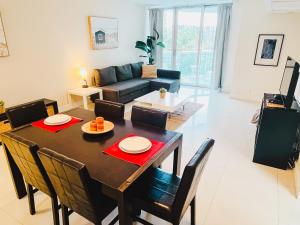 a dining room and living room with a table and chairs at Miami Hollywood Bay View on the Beach 002-1bvic in Hollywood