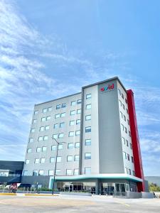 a large white building with a sign on it at avid hotels - Guadalajara Av Vallarta Pte, an IHG Hotel in Guadalajara