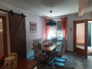 ein Esszimmer mit einem Holztisch und Stühlen in der Unterkunft Villa Luna Misevici in Hadžići