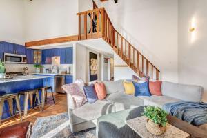 a living room with a couch and a kitchen at Ski Town Chalet in Steamboat Springs