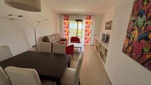 a dining room and living room with a table and chairs at Precioso piso a 10 min de la playa in Vera
