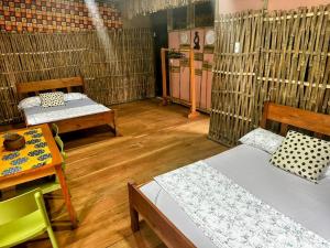 a room with two beds and a table at Hotel Campismo Praia Grande in Monte Carmo +47 photos