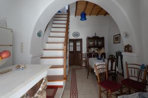 a kitchen and dining room with a spiral stairway at Marousω's Μaisonette in Dhragoulás