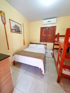a bedroom with a bed and two bunk beds at Babylon Village in Algodoal +26 photos