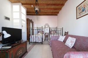 a living room with a couch and two beds at Marousω's Μaisonette in Dhragoulás