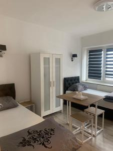 a room with a bed and a table and a dining room at Unterkunft Mara in Oberhausen