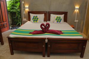 Postel nebo postele na pokoji v ubytování Negombo The Nature Villa and Cabanas
