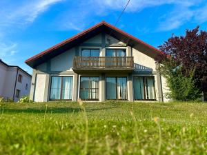 a house with a balcony on top of a yard at Apartament Contra II in Wodzisław Śląski