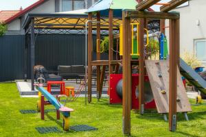a playground with a slide and a play structure at Apartament Contra II in Wodzisław Śląski