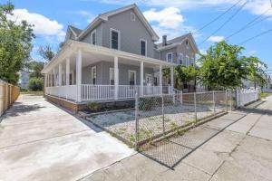 a house with a fence in front of it at Renovated Ranch Style 6BR 4BA Duplex Beach House in Atlantic City