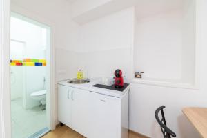 a white bathroom with a sink and a toilet at Colours Plus in Sarajevo +29 photos