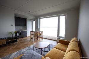 a living room with a couch and a table at Sadama Guest Apartment in Haapsalu