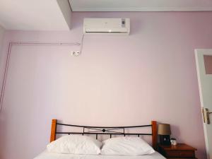 a bedroom with a bed with a white wall at Takis apartment in Sparta