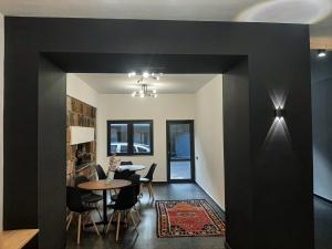 a dining room with black walls and a table at Innwoods Hotel in Alaverdi