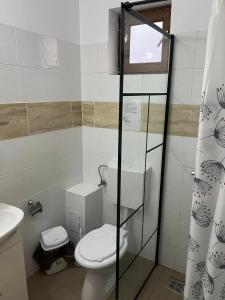 a bathroom with a toilet and a sink at Vila SIA Eforie Sud in Eforie Sud +39 photos